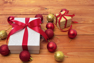 Box with gifts , christmas concept  and  red ribbon on wood background