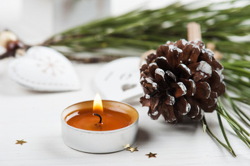 Golden lit candle, wooden christmas toys