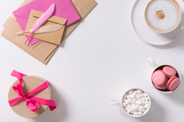 Pink feathers lying on the pile of envelopes