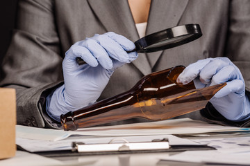 Fototapeta premium Detective through a magnifying glass looking at a evidence