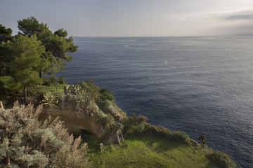 Deep blue sea waves splashing volcanic rocks, Sicily coast