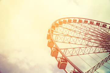 Ferris wheel on sky background with sunlight