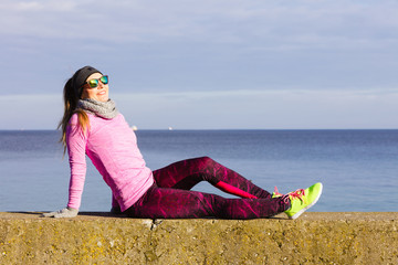 Woman resting after doing sports outdoors on cold day