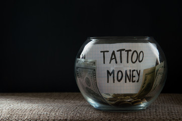 Glass jar witn money for tattoo