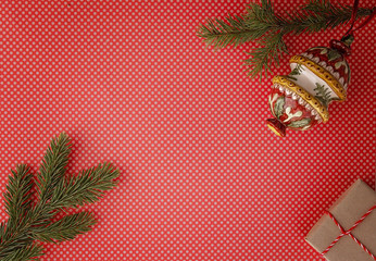 Christmas composition with fir tree branch, Xmas gifts and decorations red background. Top view, flat lay. Copy space for text