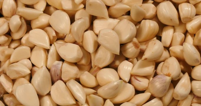 Top view of turning peeled garlic