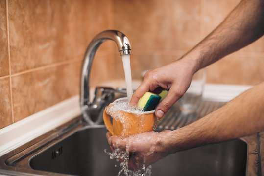 A man washes a cup