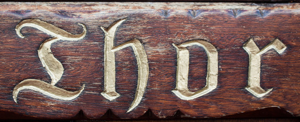 Hintergrund dunkelbraune Holztafel mit Thor Schriftzug