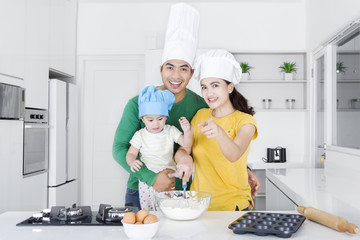 Happy family making cookie together