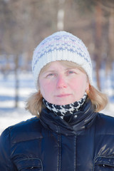 Senior blond woman in the snowy park