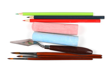 color chalks with brushes painting and color pencils isolated on white