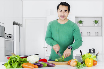 Man making salad in the kitchen