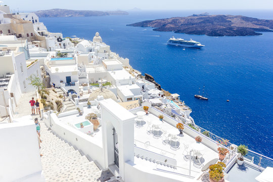 Fototapeta Beautiful panoramic view on the mediterranean sea, caldera and volcano.  Traditional white architecture of Santorini island, Thira, Greece. Cruise ship in blue sea. 