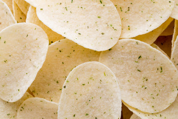Close up potato chips on wood top view background.