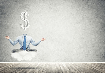 Headless meditating businessman