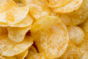Close up potato chips on wood top view background.