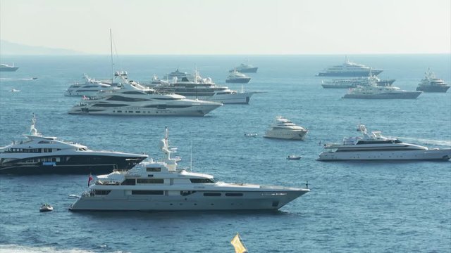 World Fair MYS Monaco Yacht Show, Port Hercules, luxury megayachts, many shuttles, taxi boat, presentations, Journalists, boat traffic, Azur water, aerial view, mountains on background, perspective