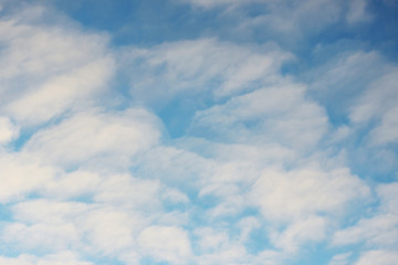 Fototapeta premium white clouds against the blue sky on a sunny winter day in the evening.