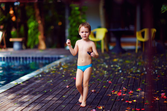 young kid with toy in hands relaxing on exotic vacation