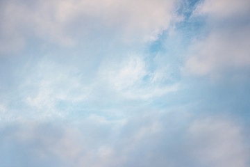 white clouds against the blue sky on a sunny winter day in the evening.