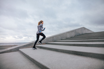 Healthy woman climbing up on stairs