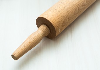 Close up of rolling pin lying on wooden table