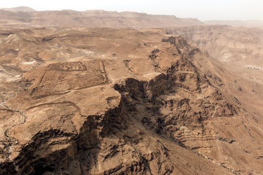 Roman military camp ruins and the Judaean desert, seen from the Masada fortress, Israel