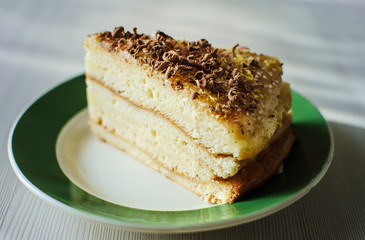 a piece of homemade biscuit cakewith chocolate sprinkles closeup