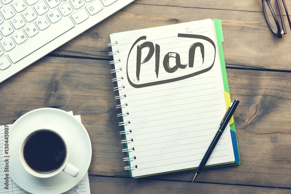 Poster plan text on notepad and keyboard
