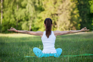 Woman doing yoga meditation in park