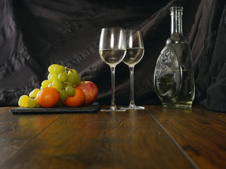Still life: Jar of wine and fruits, cloth background.