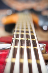 guitar with focus on bottom E string and string-tree.