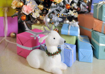Beautiful Christmas Christmas living room interior with decorated Christmas tree, fireplace, gifts, Teddy bear toy and a chair. Cards. Background
