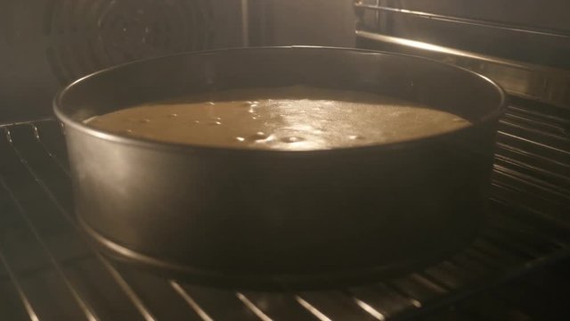 Lighted oven with baked apple pie 4K 2160p UHD tilting footage - Slow tilt on greasy electric oven with pot while being heated3840X2160 UHD video 