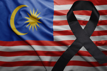 flag of malaysia with black mourning ribbon
