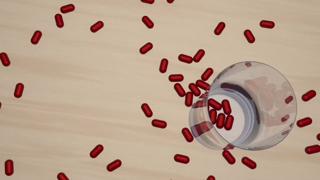 Rote Tabletten fallen auf einen Tisch mit einem Glas