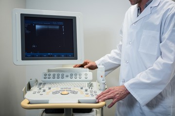 Doctors using sonography machine