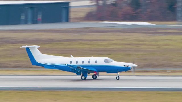 Small Generic Blue and White Turboprop Business Airplane Moving on Runway at Washington Dulles International Airport IAD