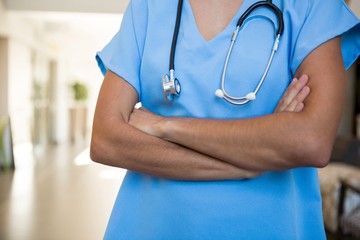 Doctor standing with arm crossed in hospital