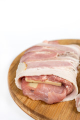 Stuffed pork chop with yellow cheese and rolled in bacon over wh