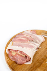 Stuffed pork chop with yellow cheese and rolled in bacon over wh