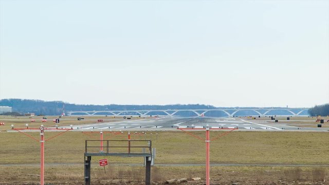 Generic Airliner Rear View Touching Down Landing on Runway with Smoke from Tires at Ronald Reagan National Airport DCA in Washington DC