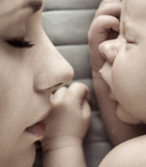 Cute sleeping newborn baby with his mother