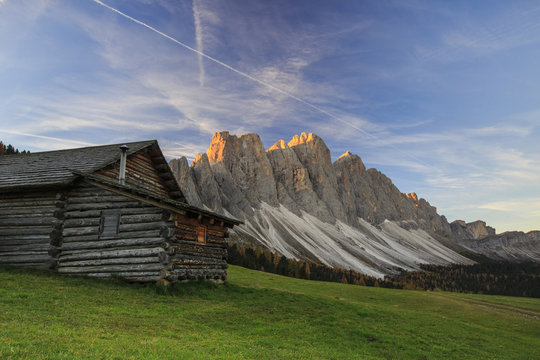 The early morning light illuminates Malga Zannes and the Odle in background, Funes Valley, South Tyrol, Dolomites