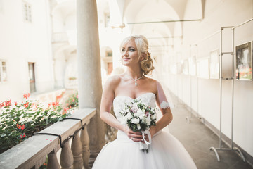 Luxury wedding bride, girl posing and smiling with bouquet