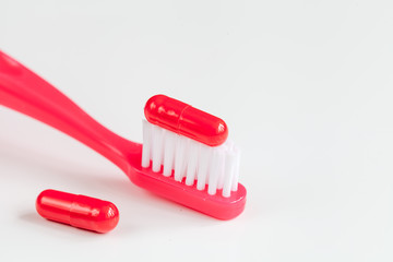 concept toothache with toothbrush and tablet at white background