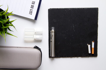 concept of electronic cigarette on white background top view