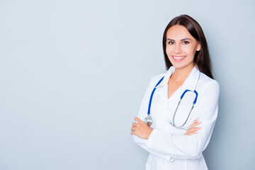 Cheerful happy doctor  with crossed hands on blue background