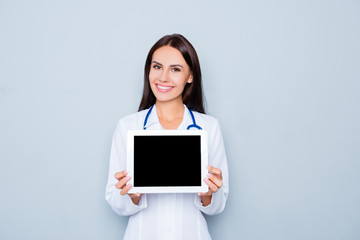 Pretty young doctor demonstrating black screen of tablet