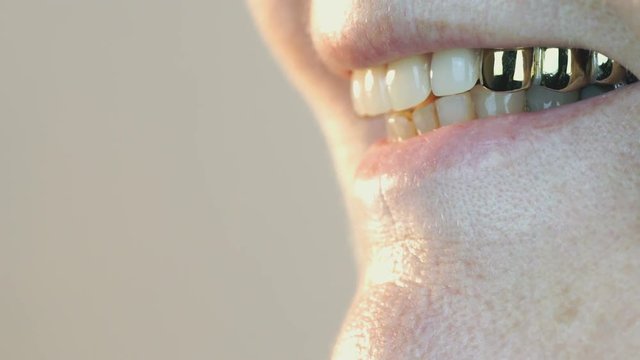 Mouth of elderly woman with false teeth. Close up